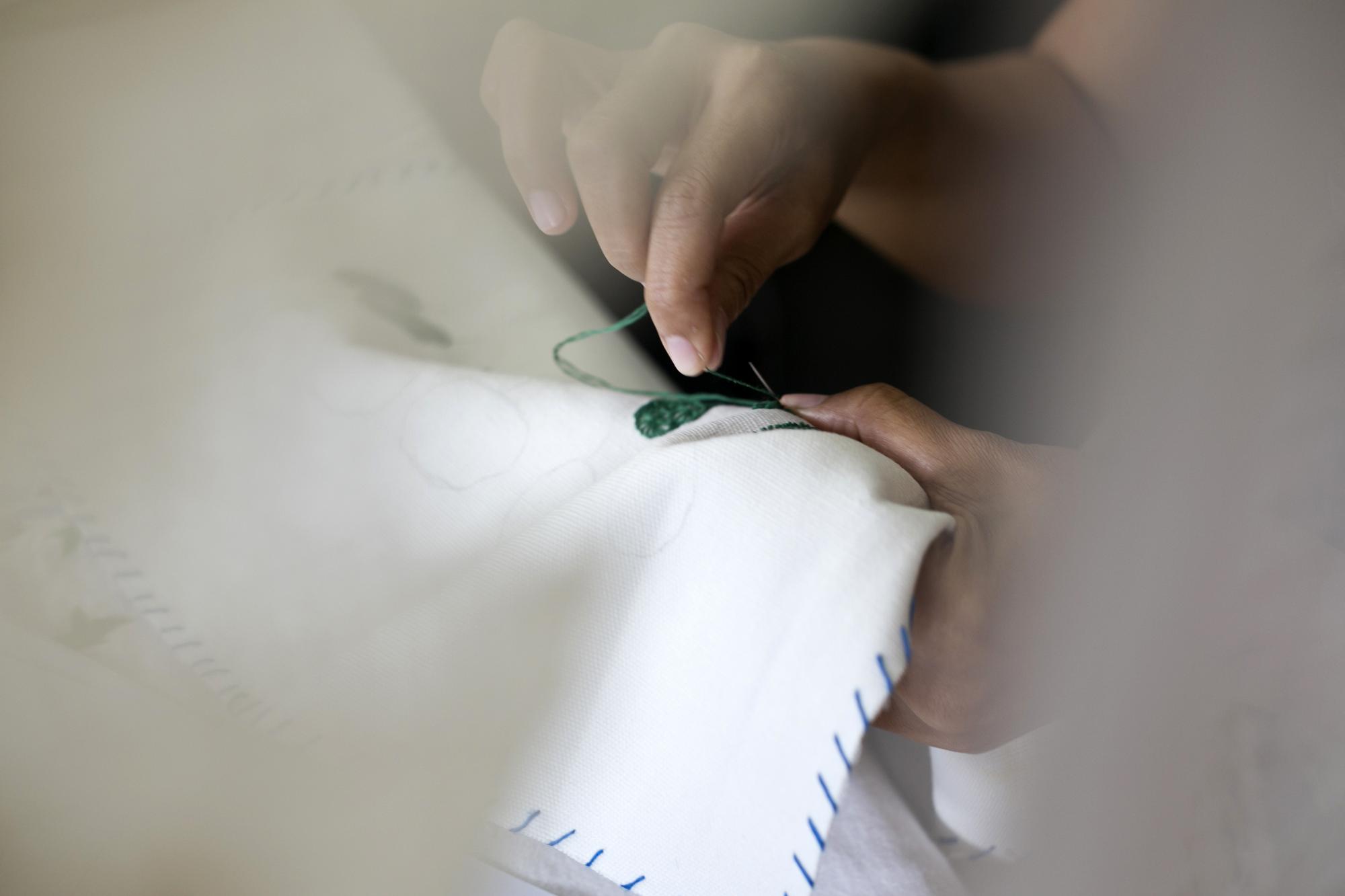 Hand finishing edge of embroidered patch